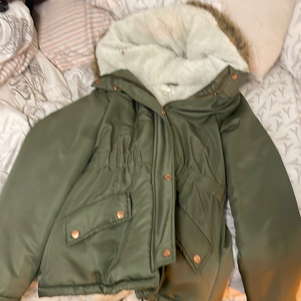 Green, fuzzy on the inside. Has a brown animal coat on the hood